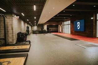 The P3 facility floor — a wide-angle view of the assessment lab, sprint track, and P3 logo display wall