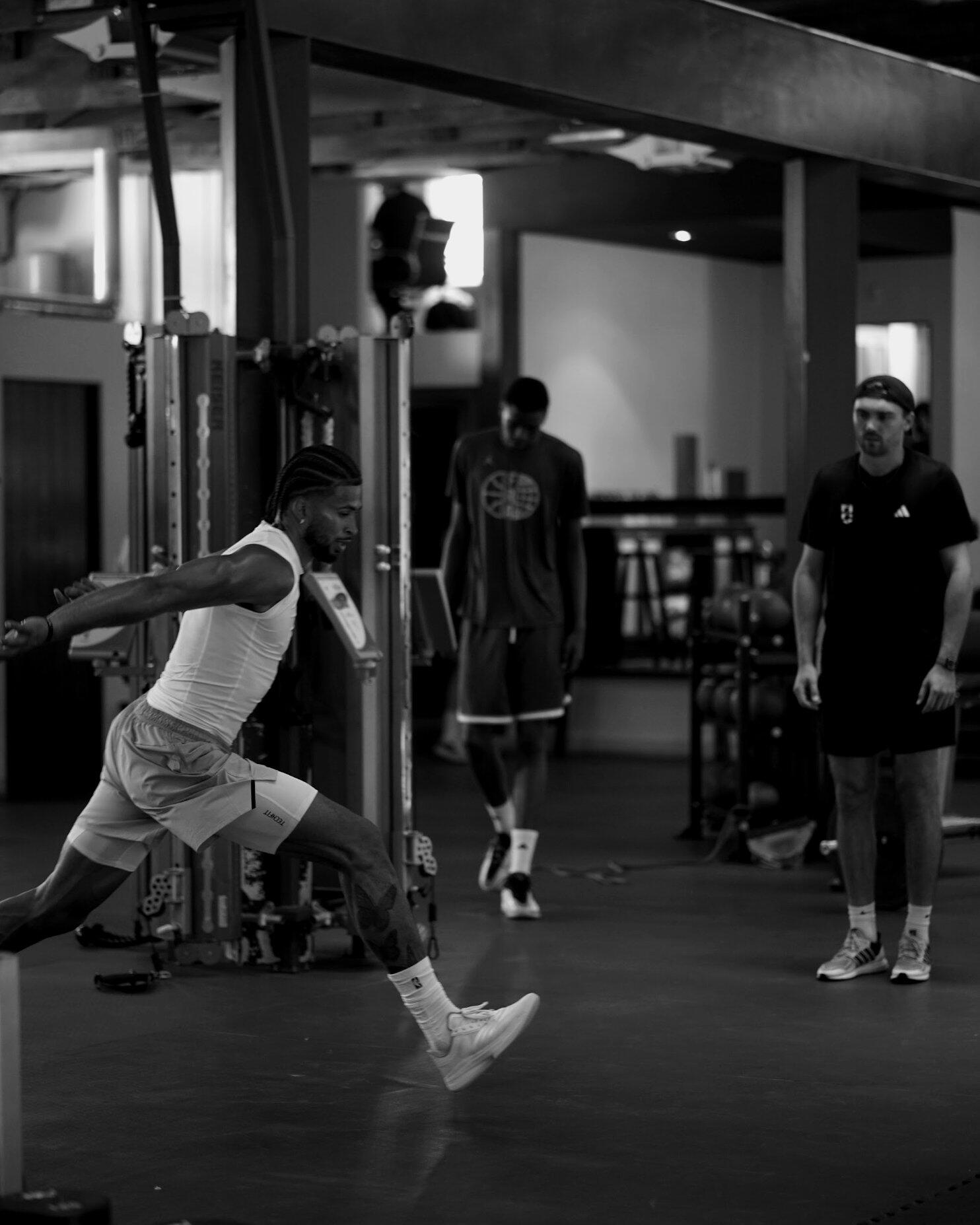 Athlete performing a lateral bound while P3 coaches observe