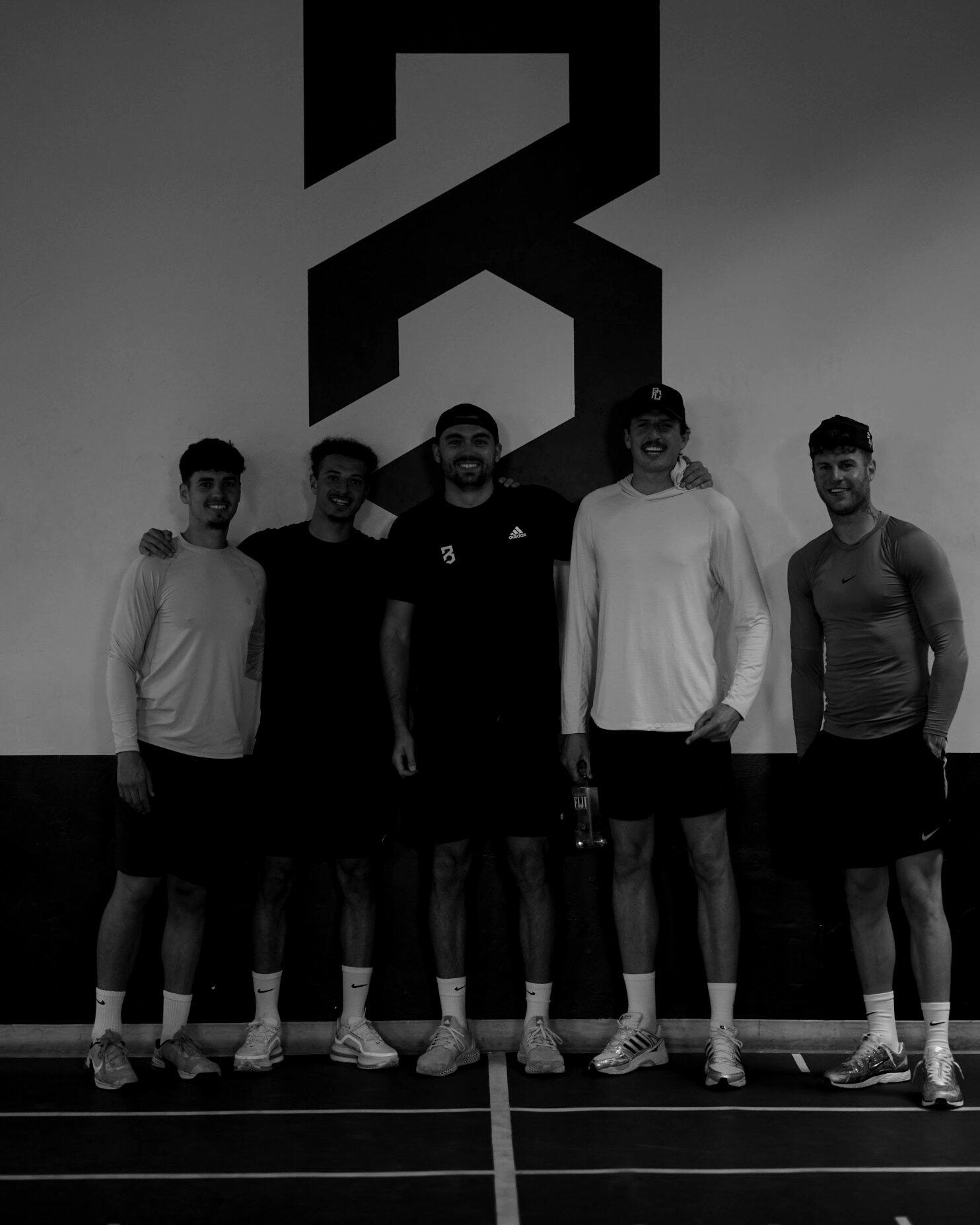 P3 staff in front of the P3 logo wall